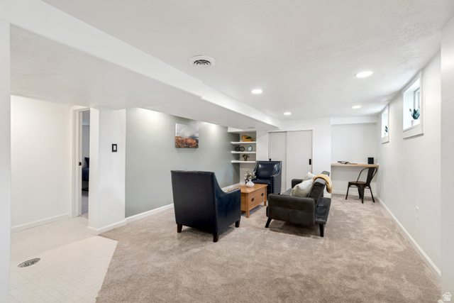 4883 South Center Street Murray, UT 84107 - Photo 19 of 32 Lower level space featuring recessed lighting, plush carpeting, built-in shelving, and a wall-mounted desk