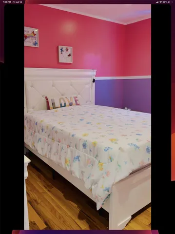 a bedroom with a bed and a night stand