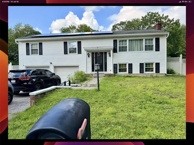 a front view of a house with a garden and yard