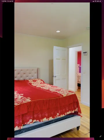 a bedroom with a bed and a painting on the wall