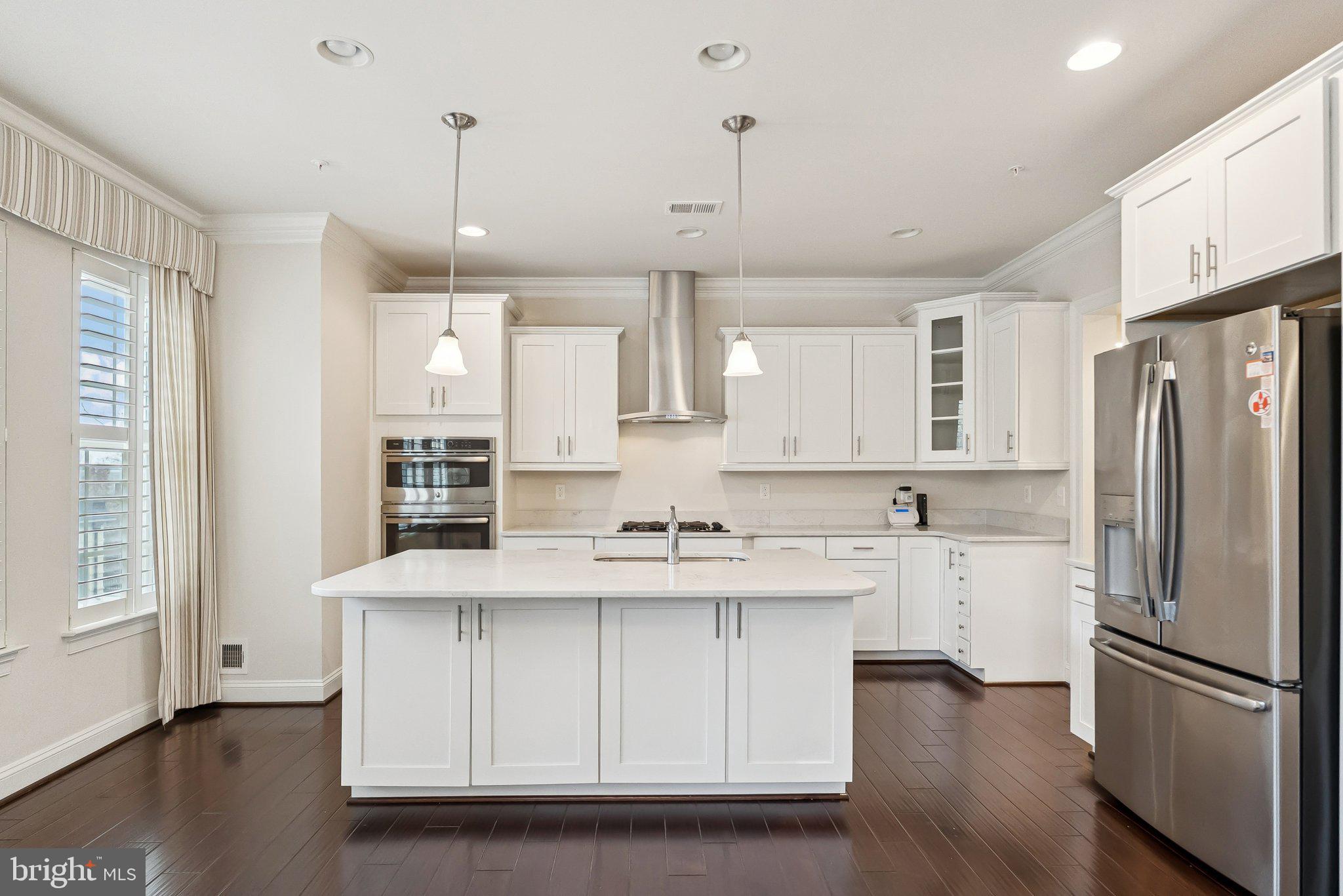 608 Fair Winds Way, Unit 262A Oxon Hill, MD 20745 - Photo 11 of 48 a kitchen with stainless steel appliances granite countertop a refrigerator a sink dishwasher a stove and white cabinets with wooden floor