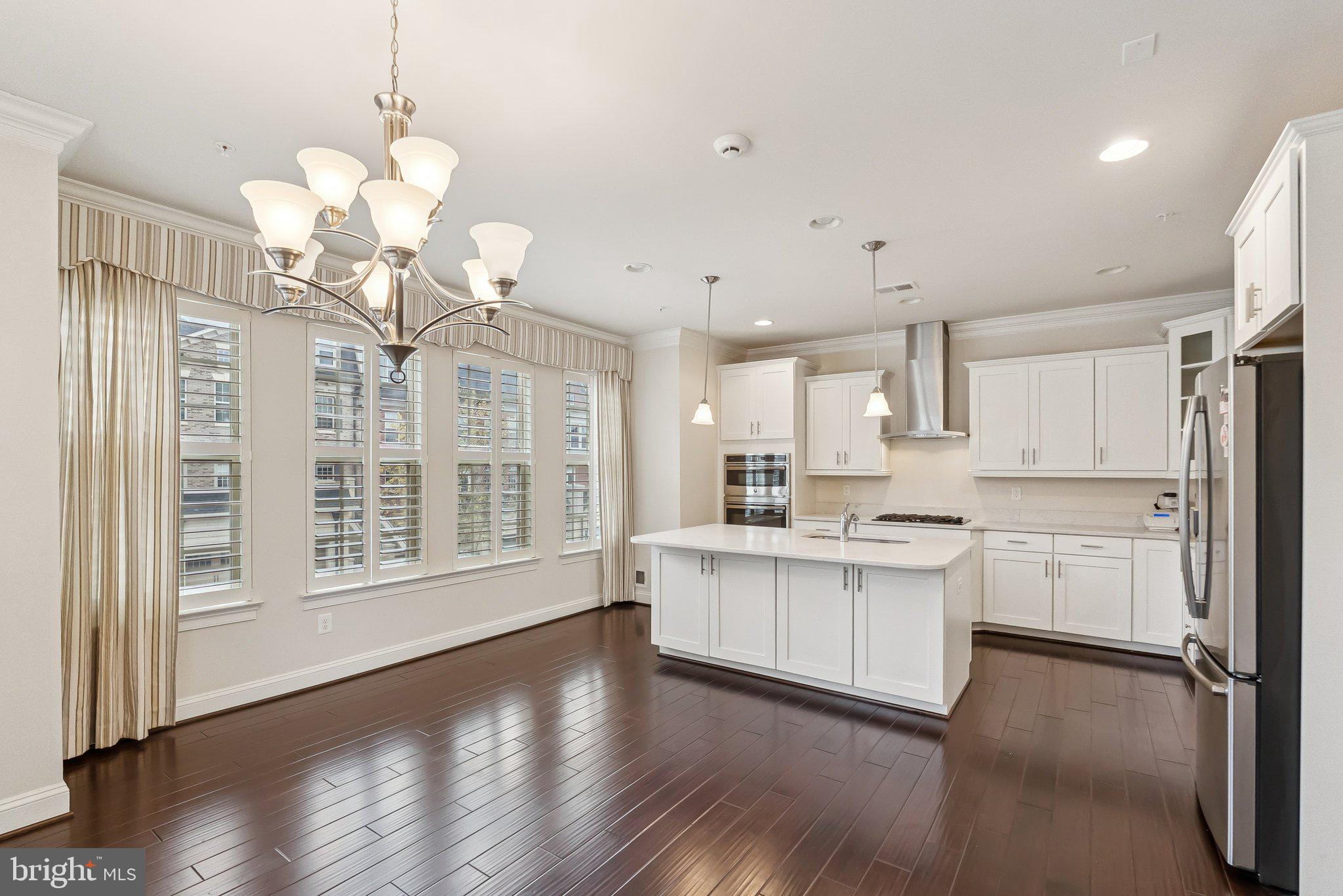 608 Fair Winds Way, Unit 262A Oxon Hill, MD 20745 - Photo 12 of 48 a large white kitchen with granite countertop a stove oven and white cabinets