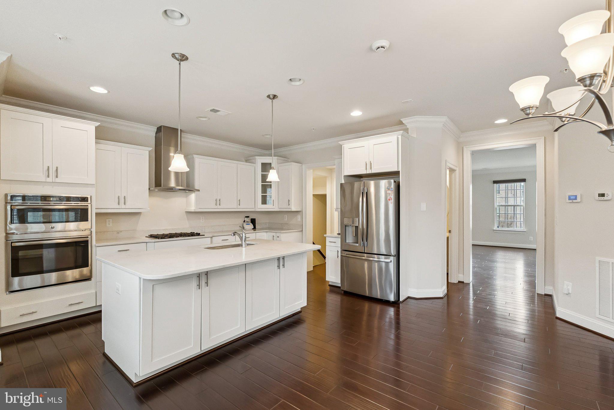 608 Fair Winds Way, Unit 262A Oxon Hill, MD 20745 - Photo 15 of 48 a kitchen with stainless steel appliances kitchen island granite countertop a refrigerator a stove and a wooden floors