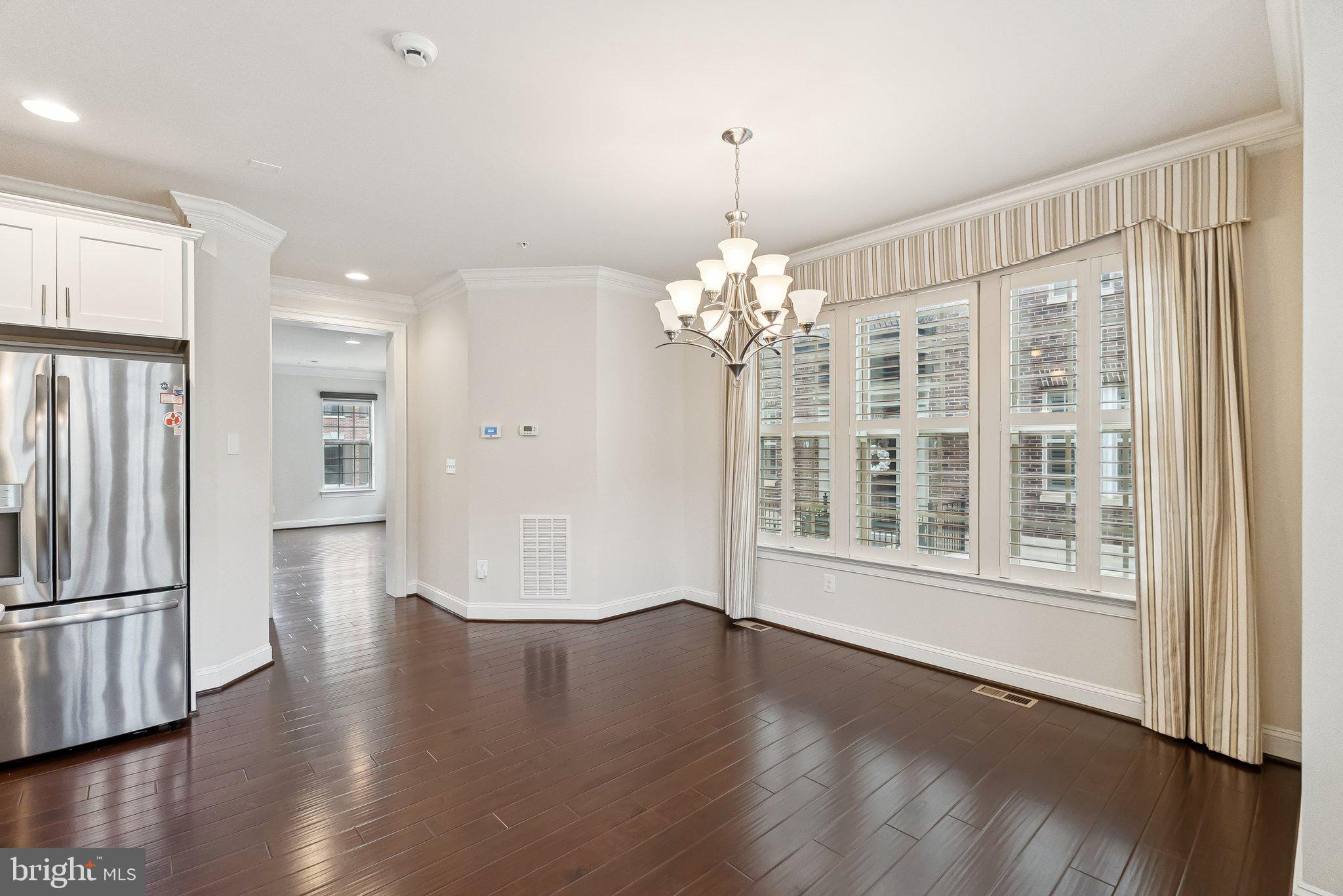 608 Fair Winds Way, Unit 262A Oxon Hill, MD 20745 - Photo 16 of 48 a view of an empty room with wooden floor and a window