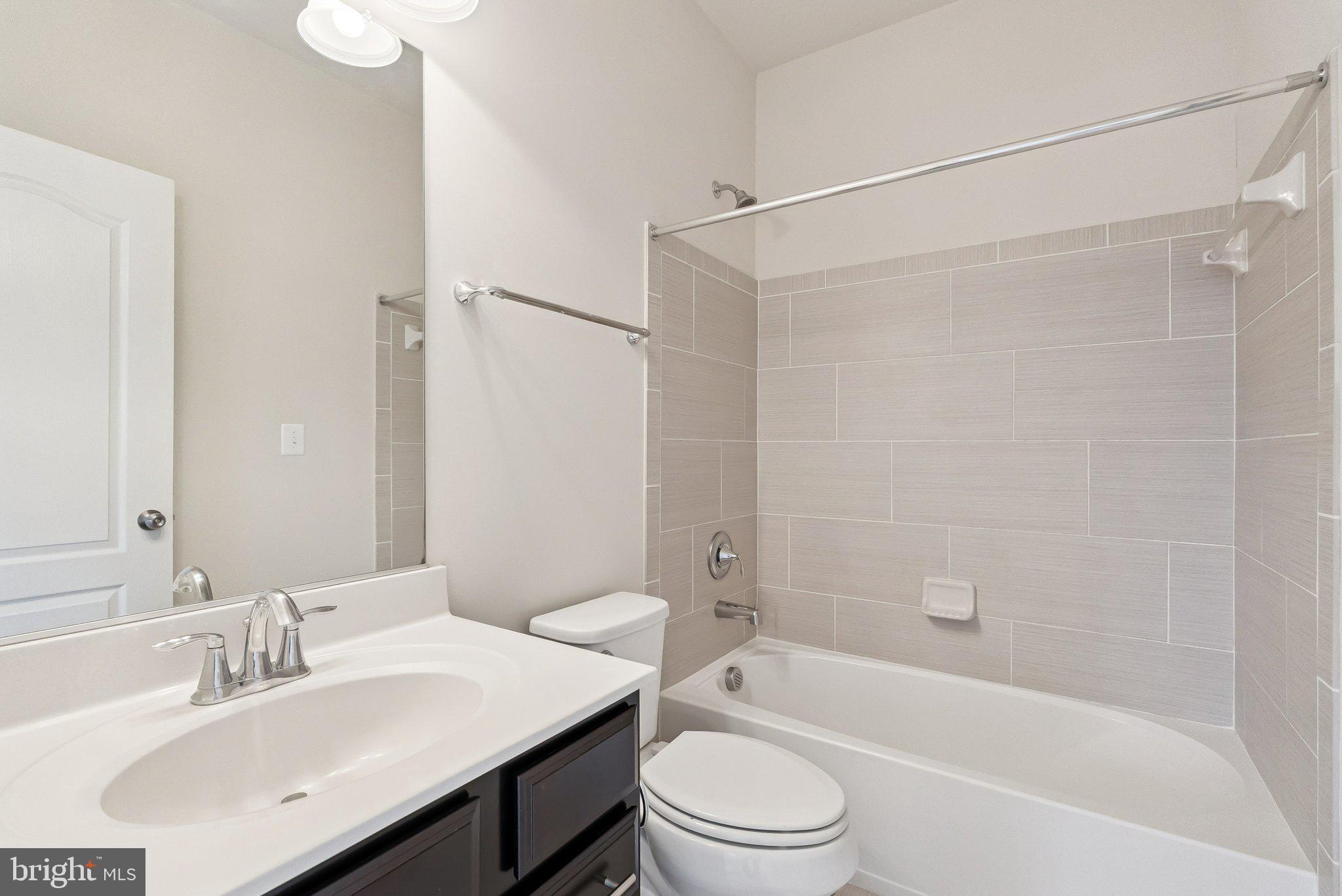 608 Fair Winds Way, Unit 262A Oxon Hill, MD 20745 - Photo 25 of 48 a bathroom with a bathtub shower sink vanity mirror and toilet