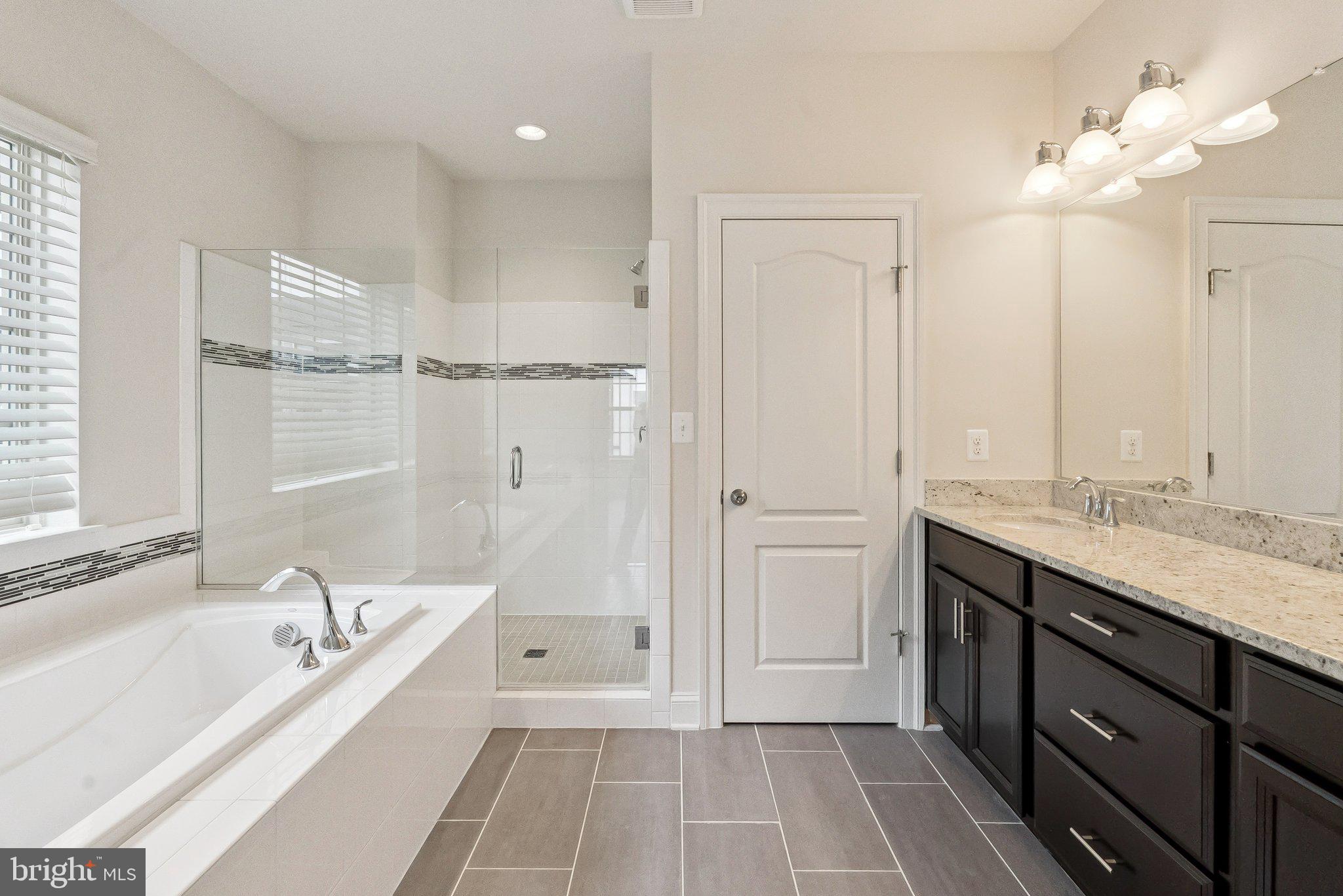 608 Fair Winds Way, Unit 262A Oxon Hill, MD 20745 - Photo 29 of 48 a spacious bathroom with a tub double vanity sink and a mirror