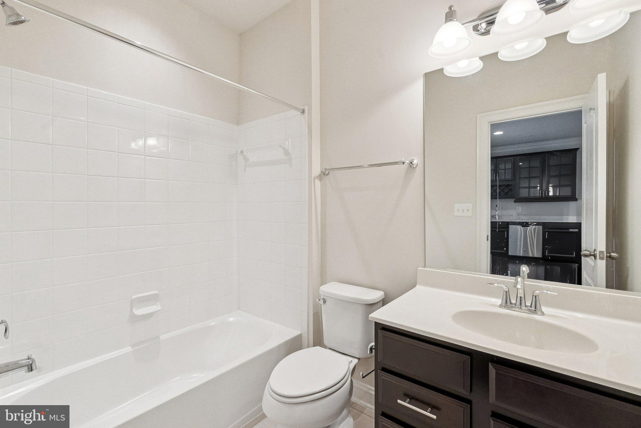 608 Fair Winds Way, Unit 262A Oxon Hill, MD 20745 - Photo 35 of 48 a bathroom with a sink a toilet a mirror and shower