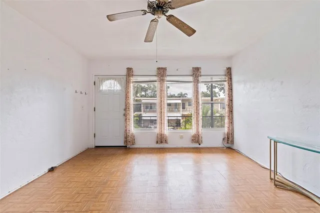 a kitchen with cabinets stainless steel appliances and wooden floor