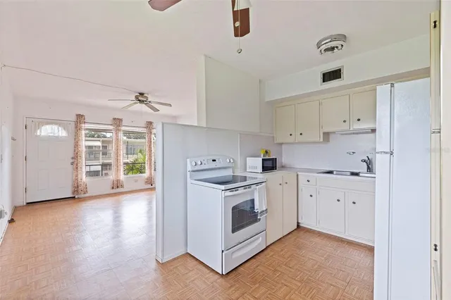 a kitchen with cabinets appliances and a sink