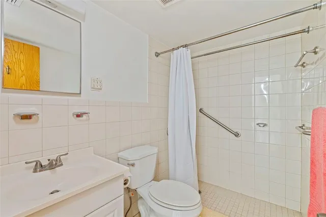 a bedroom with a bed and a ceiling fan