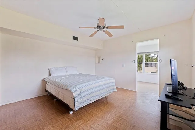 a bedroom with a bed and a desk