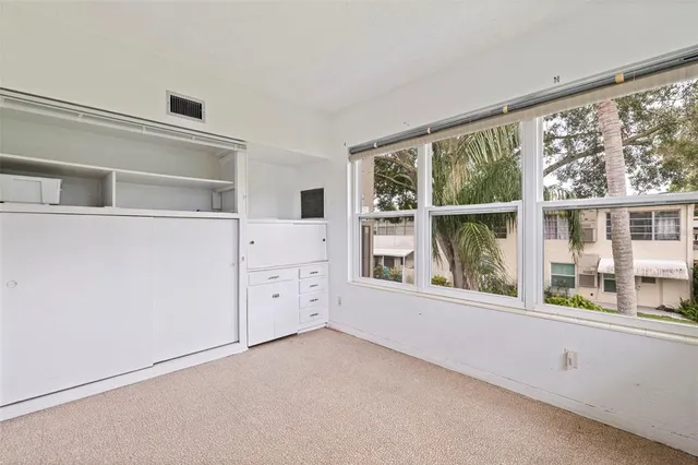 a view of a closet area and bedroom