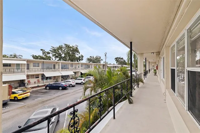 a view of a balcony with cars parked