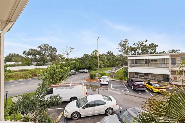 a view of an empty room with a ceiling fan and window