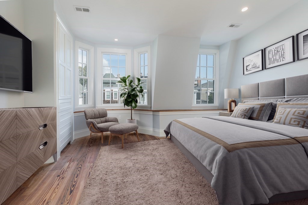 793 East 4th Street Boston, MA 02127 - Photo 16 of 17 a spacious bedroom with a bed and a couch