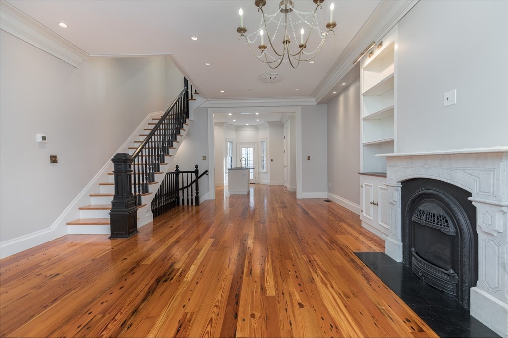 793 East 4th Street Boston, MA 02127 - Photo 2 of 17 a view of a livingroom with wooden floor and staircase