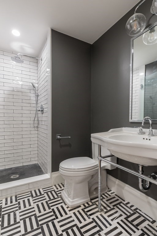 793 East 4th Street Boston, MA 02127 - Photo 6 of 17 a bathroom with a granite countertop toilet a sink and a mirror