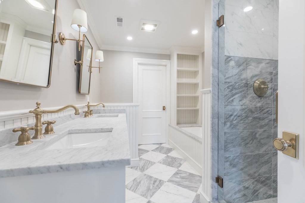 793 East 4th Street Boston, MA 02127 - Photo 7 of 17 a bathroom with a double vanity sink mirror and shower