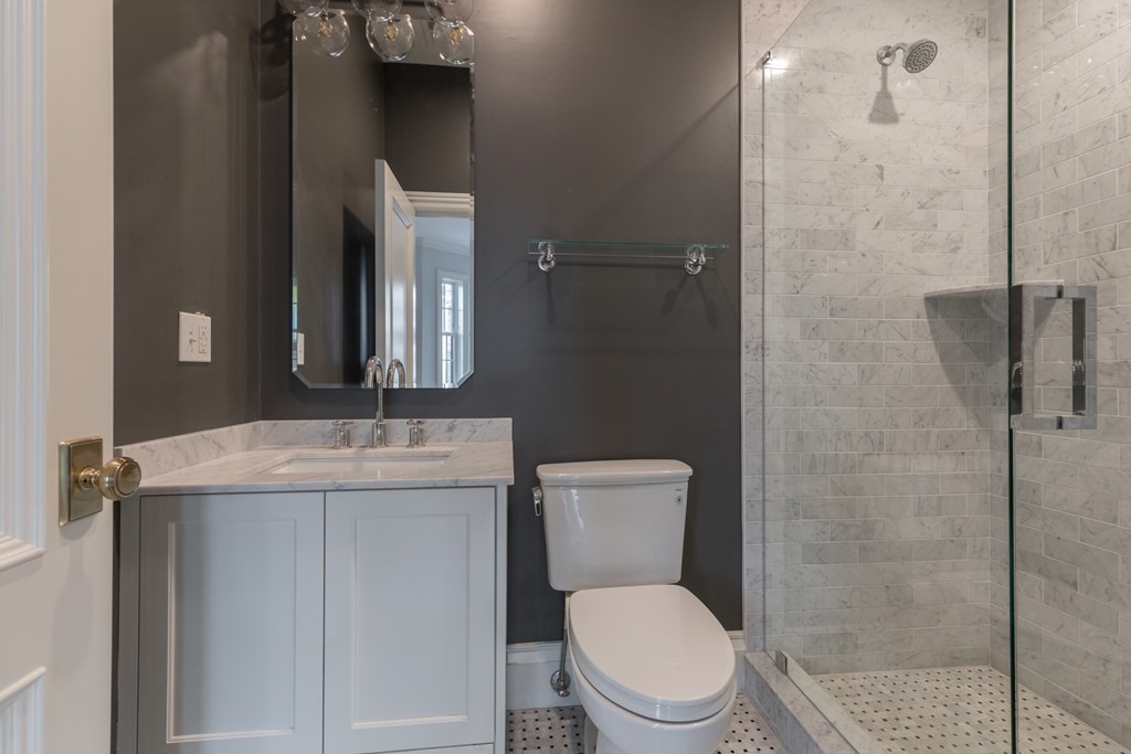793 East 4th Street Boston, MA 02127 - Photo 10 of 17 a bathroom with a granite countertop toilet sink and mirror