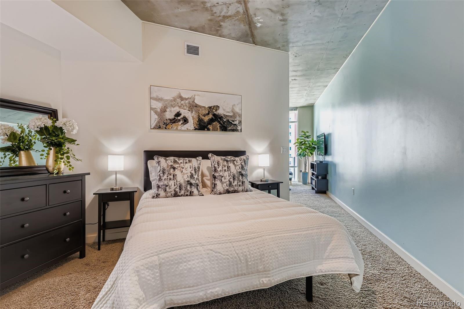 891 14th Street, Unit 1111L Denver, CO 80202 - Photo 11 of 39 a bedroom with a bed and a table