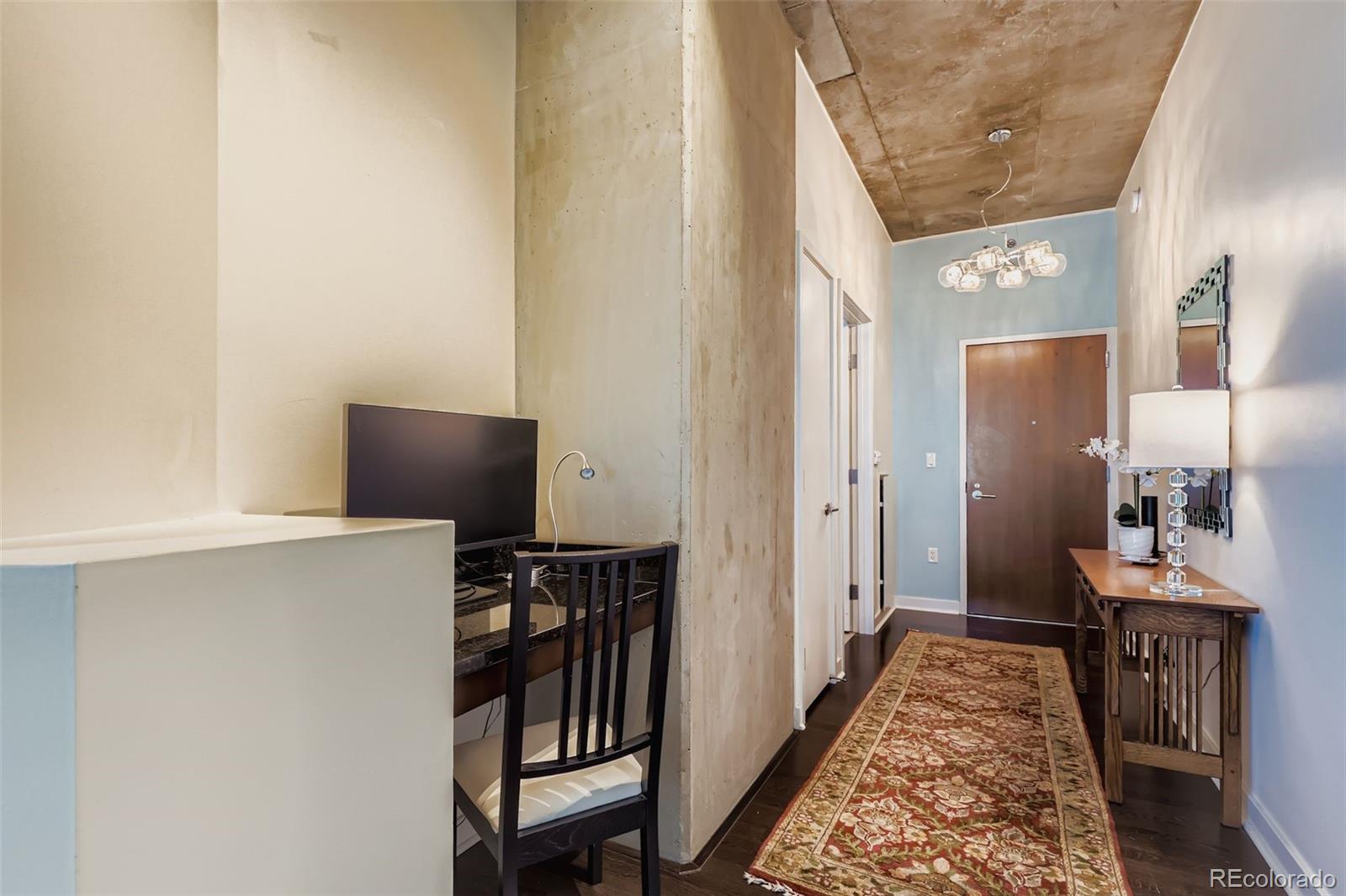 891 14th Street, Unit 1111L Denver, CO 80202 - Photo 16 of 39 a view of a hallway with workspace and wooden floor