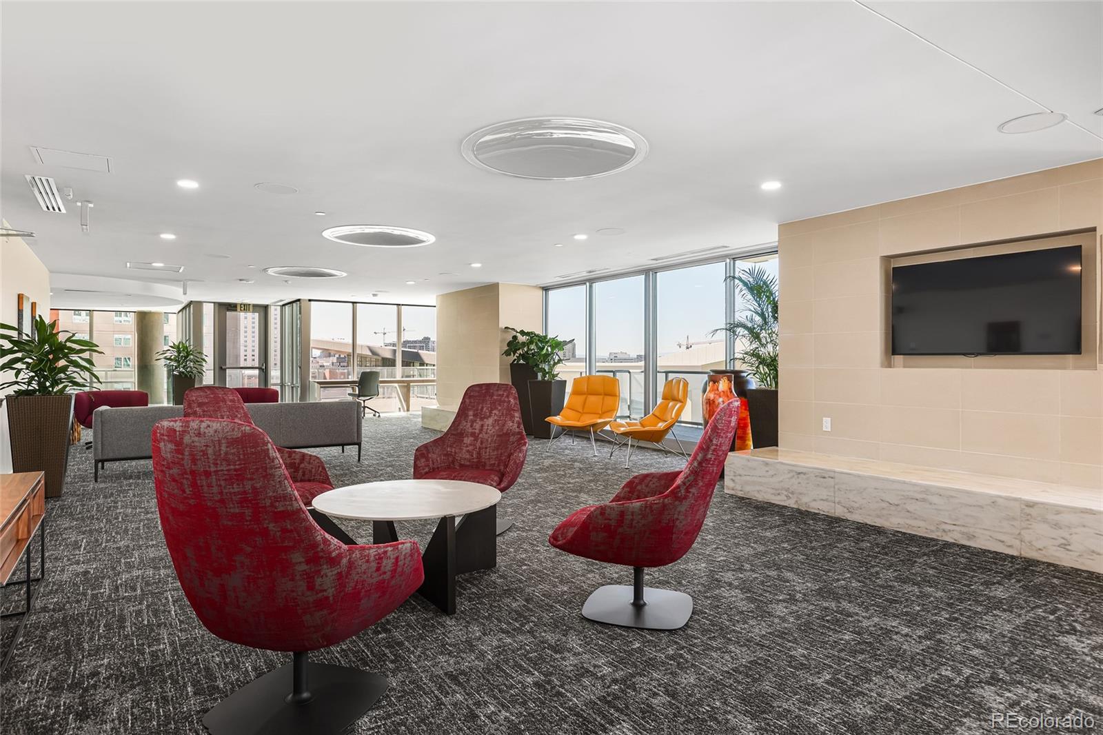 891 14th Street, Unit 1111L Denver, CO 80202 - Photo 30 of 39 a living room with furniture a flat screen tv and kitchen view