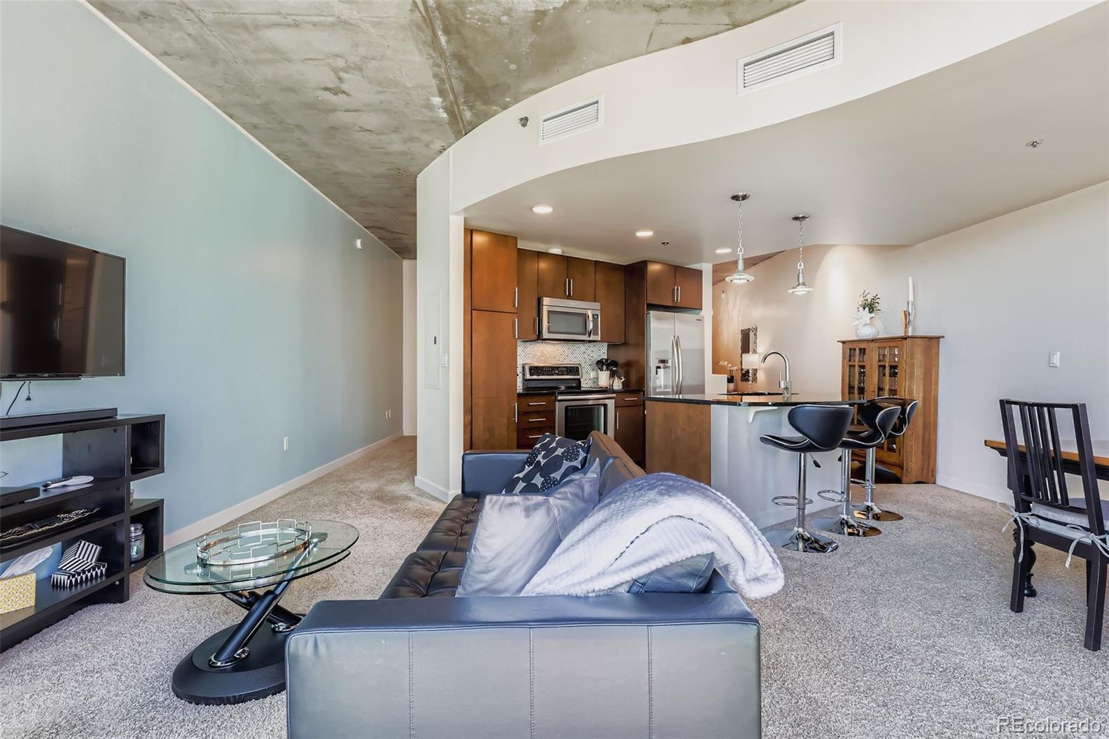 891 14th Street, Unit 1111L Denver, CO 80202 - Photo 7 of 39 a living room with furniture and a flat screen tv