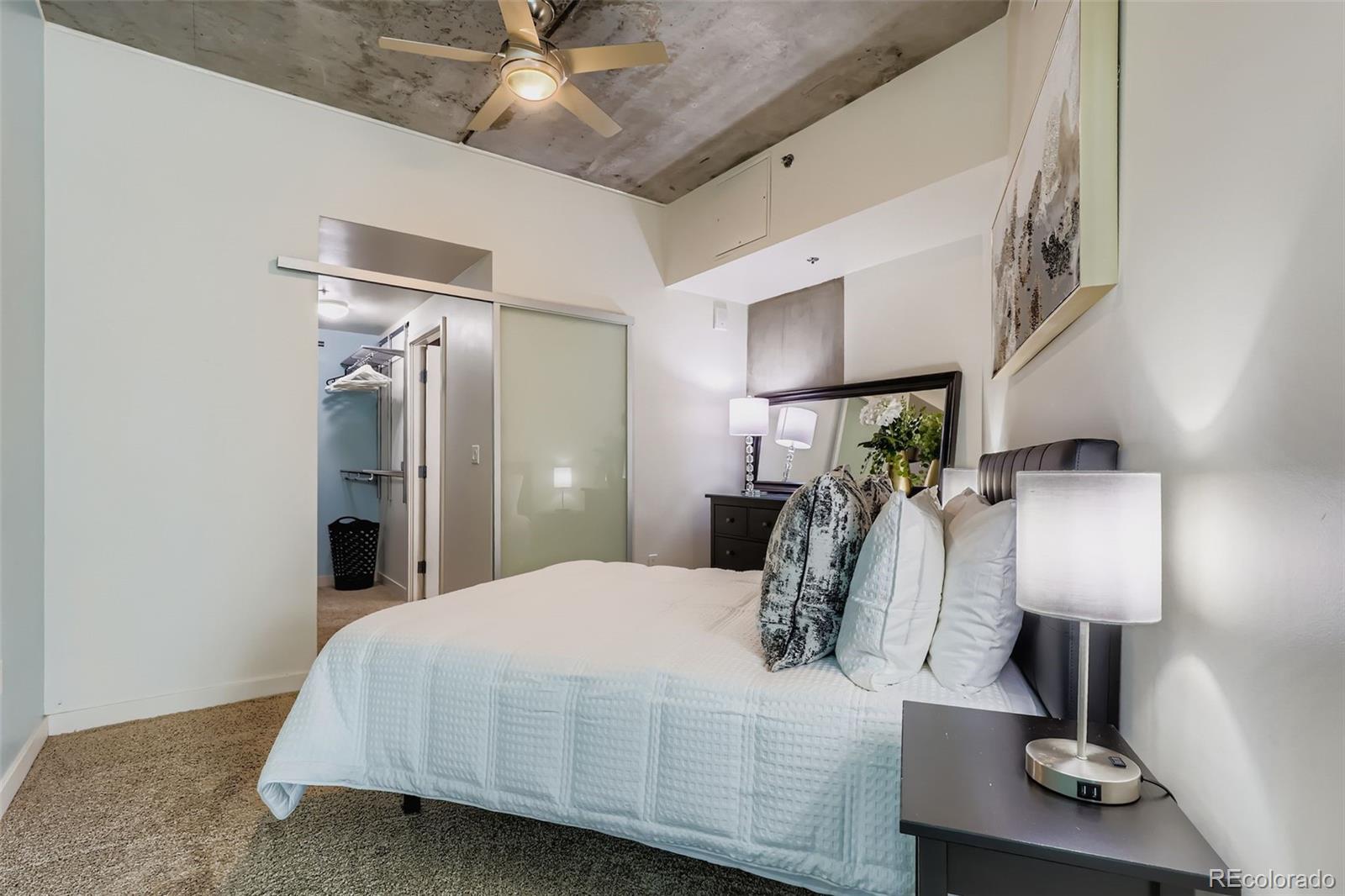 891 14th Street, Unit 1111L Denver, CO 80202 - Photo 10 of 39 a bed room with a bed and a lamp