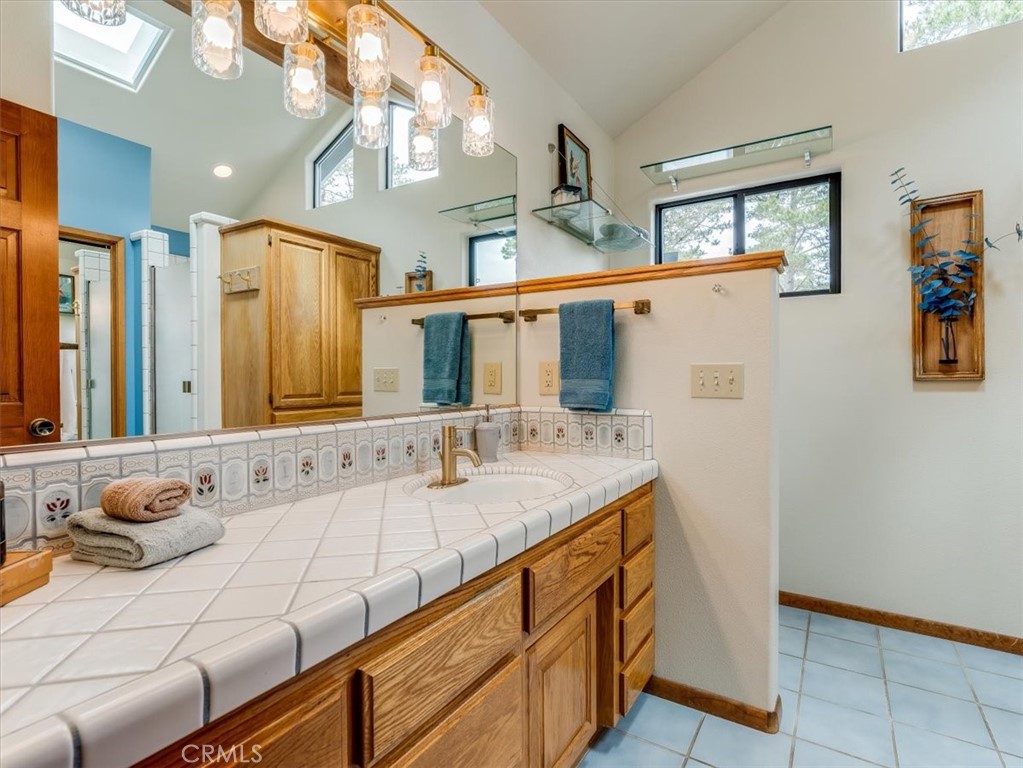 1810 Melrose Avenue Cambria, CA 93428 - Photo 29 of 74 a bathroom with a granite countertop sink and a mirror