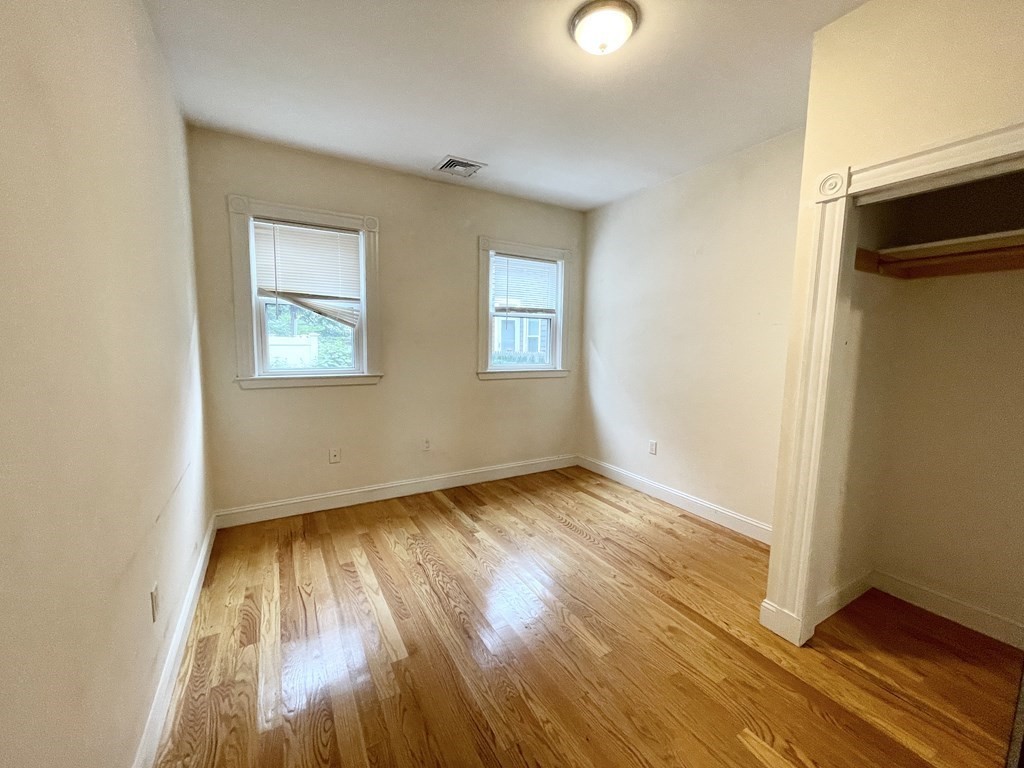 98 L Street, Unit STREET Boston, MA 02127 - Photo 6 of 19 an empty room with wooden floor and windows