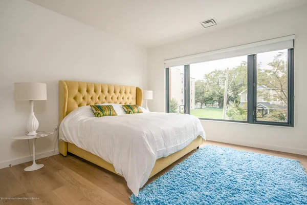 a bed sitting in a bedroom next to a window