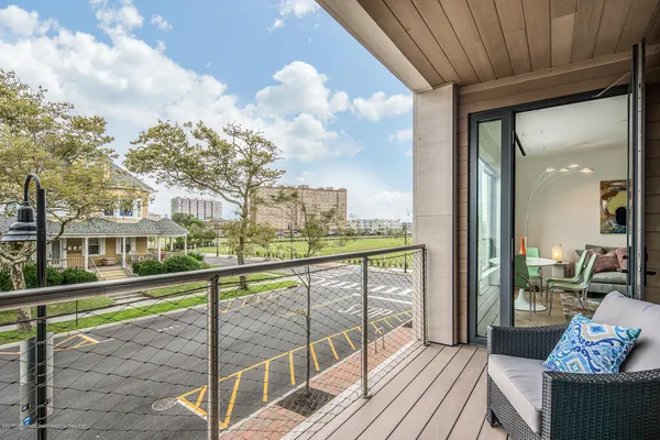 a view of a balcony with wooden floor