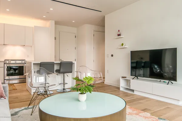 a dining room with furniture and a flat screen tv