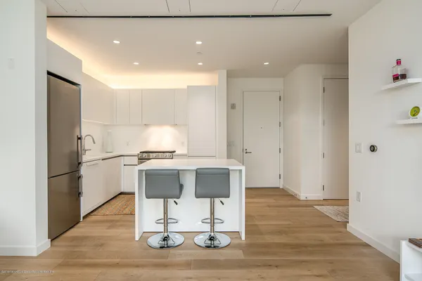 a kitchen with a refrigerator and a stove top oven