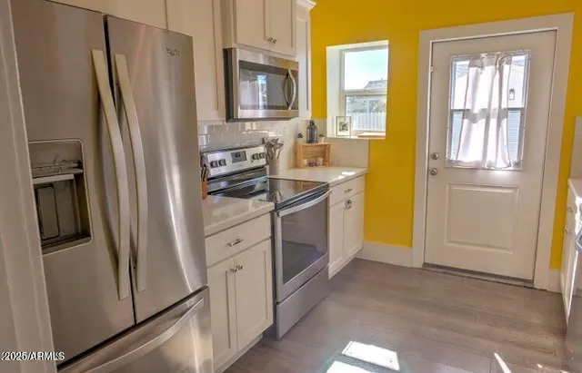 a kitchen with a refrigerator stove and sink