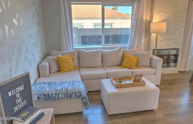 a living room with furniture and a large window