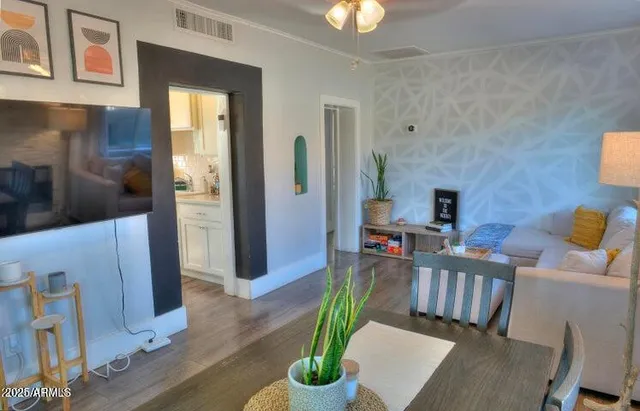 a living room with furniture and a chandelier
