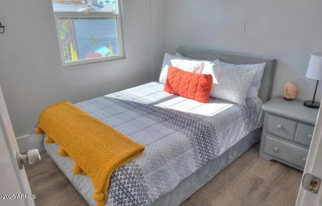 a bedroom with a bed and a lamp