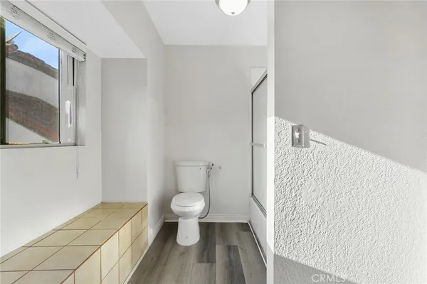 a bathroom with a toilet and a mirror