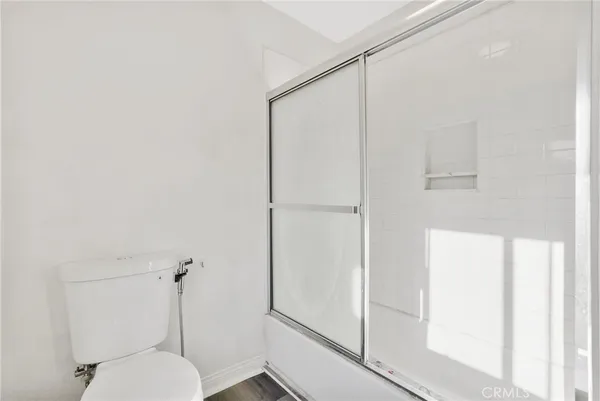 a bathroom with a shower and toilet