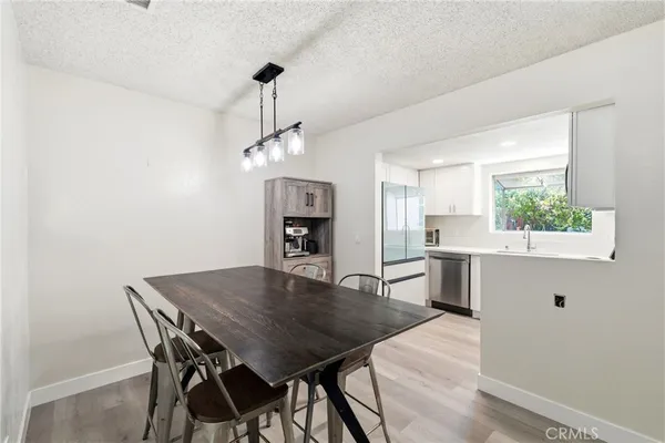 a dining room with a wooden table and chairs