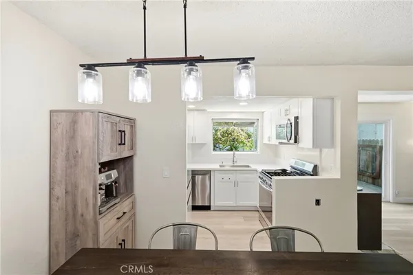 a kitchen with stainless steel appliances kitchen island granite countertop a sink and cabinets