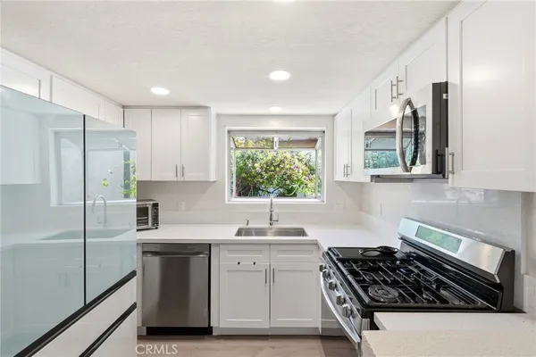 a kitchen with a sink stove and refrigerator