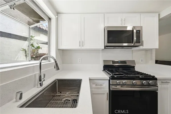 a kitchen with a sink and a stove top oven