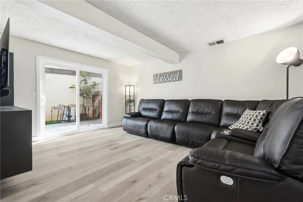 a living room with a couch and a wooden floor