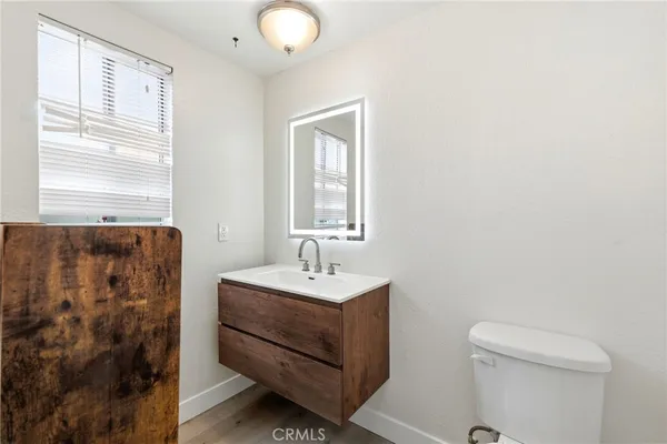 a bathroom with a sink a toilet and a window