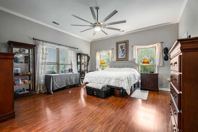 a bedroom with a bed window and a flat screen tv