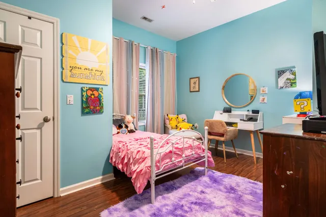 a bedroom with a bed and a dresser