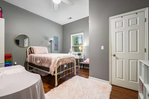 a bedroom with bed and a chandelier