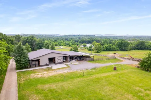 a view of a house with swimming pool and a yard
